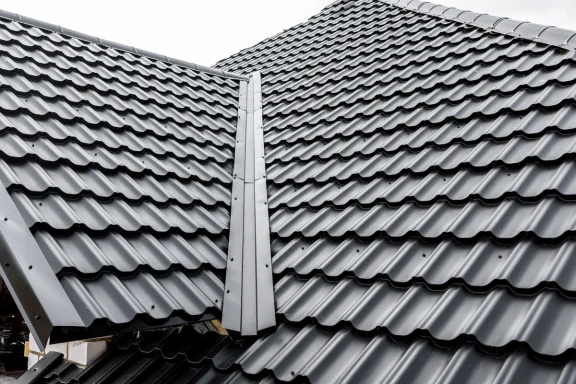 Dark metal shingles on a residential roof.