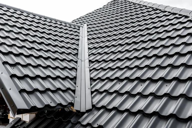 Dark metal shingles on a residential roof.
