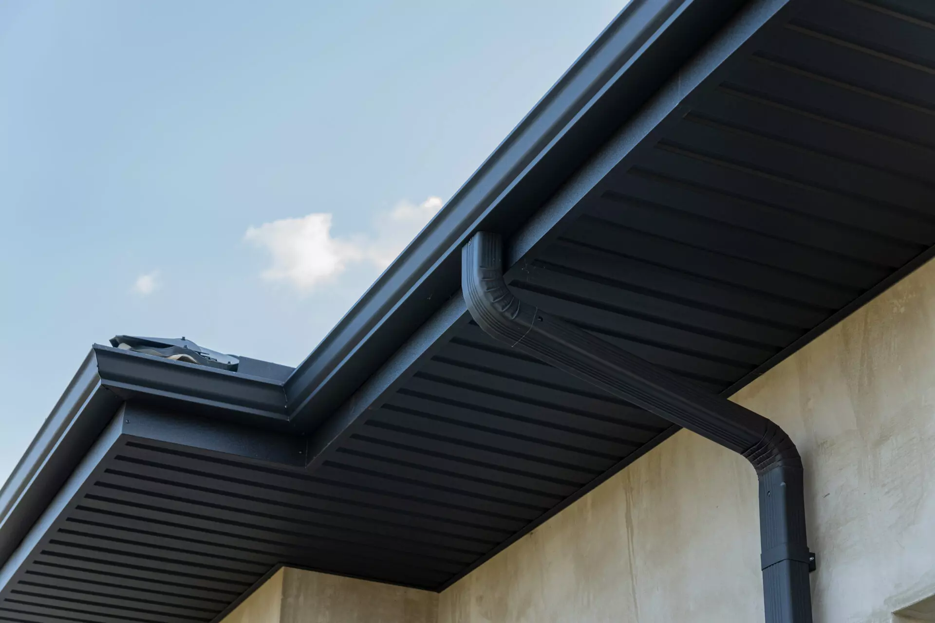 Black seamless guttering installed on a home.