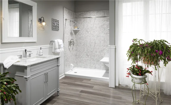A gray, remodeled bathroom with zer0-entry shower.
